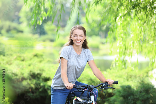 Young woman riding bicycle ...