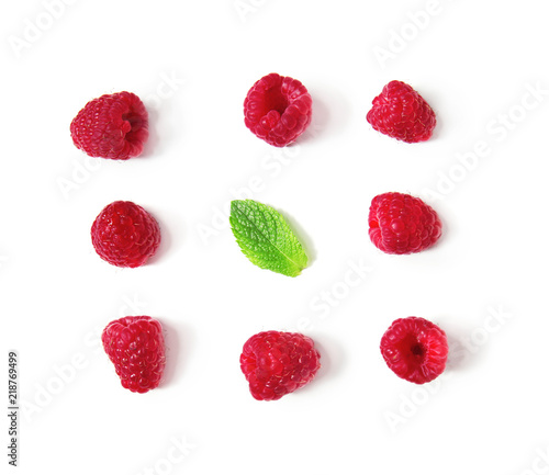 Fresh ripe raspberries with mint on white background