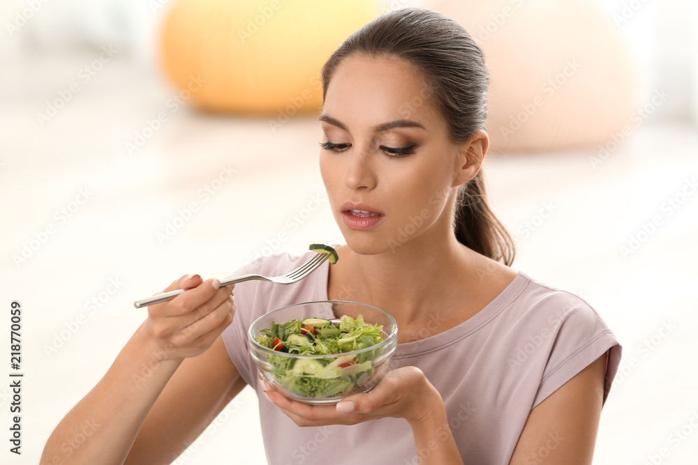 Young woman eating fresh vegetable salad at home Young woman eating fresh vegetable salad at home