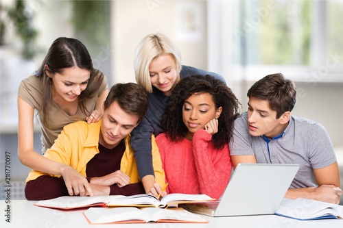 Young students studying on library background