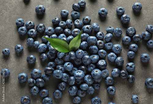 Ripe blueberries on grey background