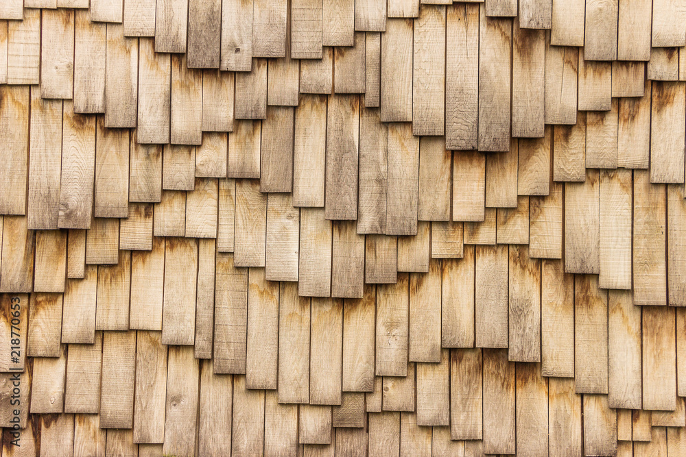 Wooden surface in waves form. Abstract wavy brown background - vintage effect style wooden design. Wooden shingles are composed of many individual elements, planks, small boards.Waved natural pattern Wooden surface in waves form. Abstract wavy brown background - vintage effect style wooden design. Wooden shingles are composed of many individual elements, planks, small boards.Waved natural pattern