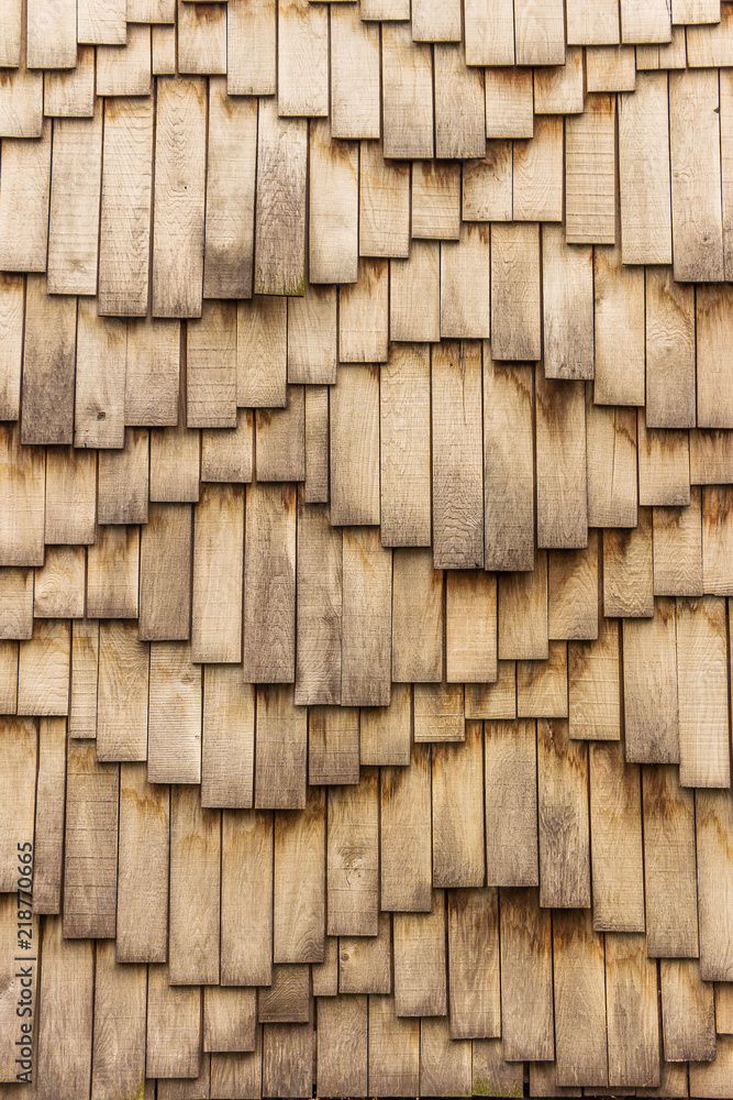 Wooden surface in waves form. Abstract wavy brown background - vintage effect style wooden design. Wooden shingles are composed of many individual elements, planks, small boards.Waved natural pattern Wooden surface in waves form. Abstract wavy brown background - vintage effect style wooden design. Wooden shingles are composed of many individual elements, planks, small boards.Waved natural pattern