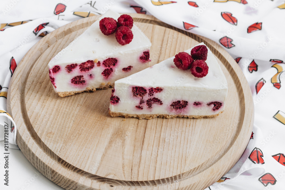 Two pieces of delicious cake with raspberries, sweet dessert Two pieces of delicious cake with raspberries, sweet dessert