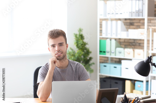Handsome man working on lap...
