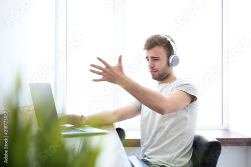 Emotional young man working...