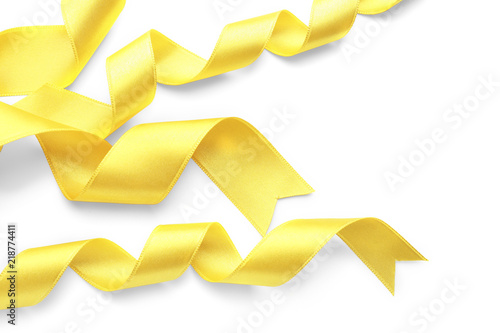 Yellow satin ribbons on white background