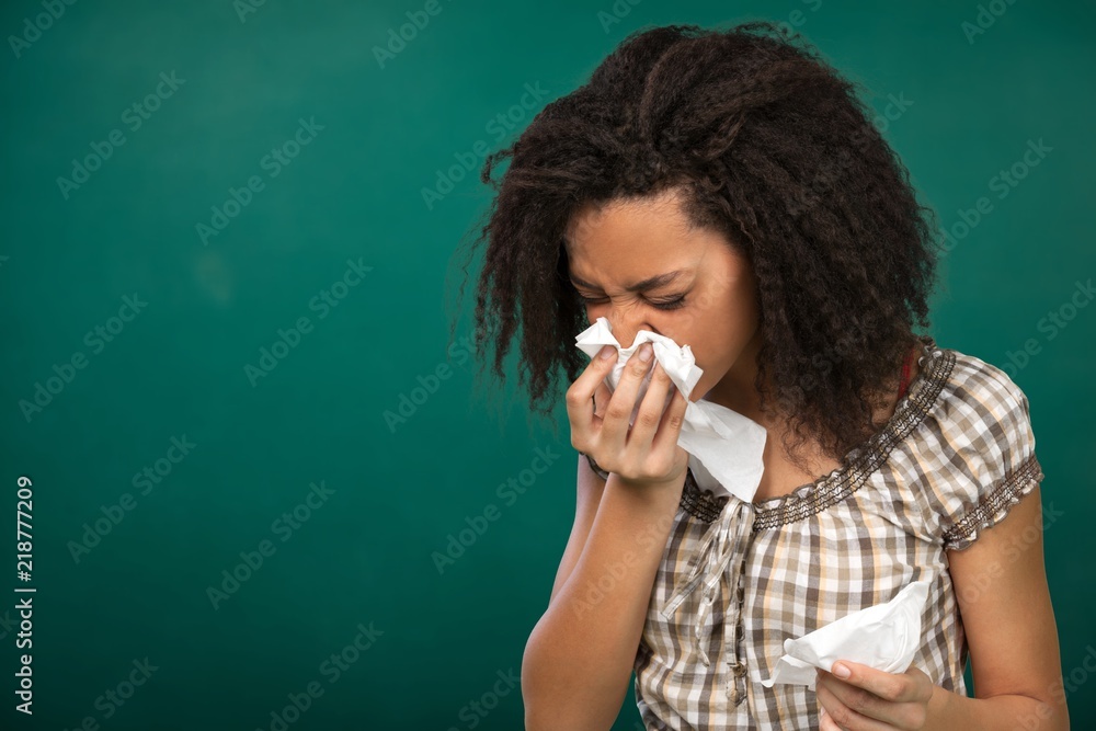 © BillionPhotos.com - Young afro american girl sneezing on background