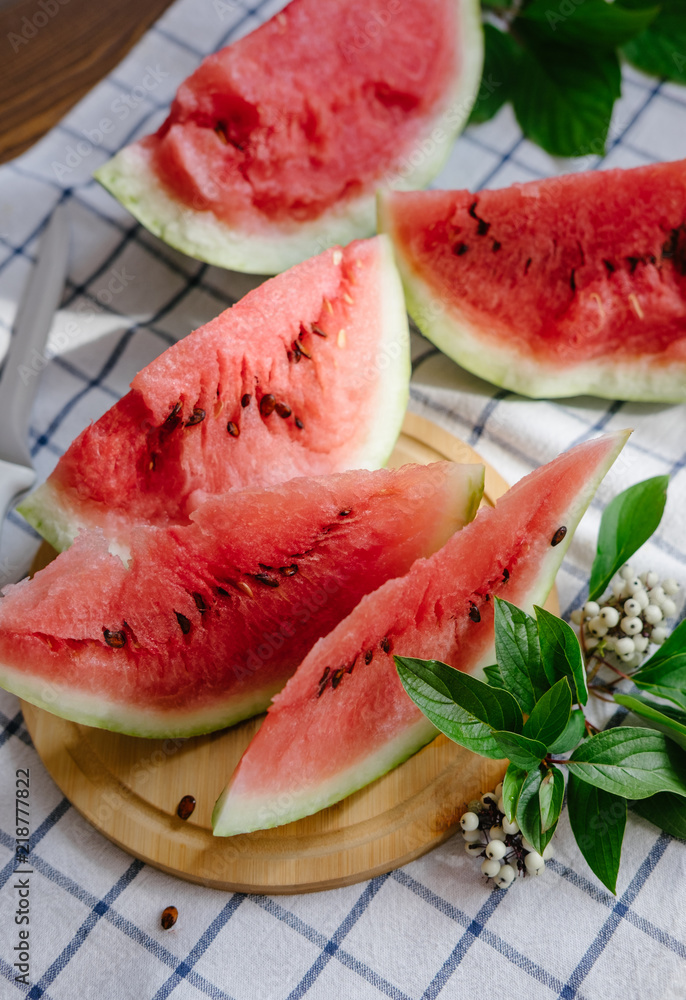 Slices of a watermelon on plate on a table Slices of a watermelon on plate on a table
