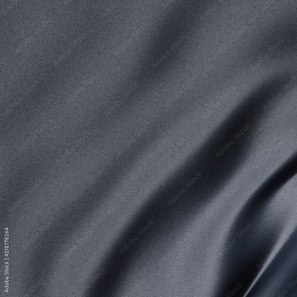 Close-up on a synthetic gray sheet with slightly blue reflection Close-up on a synthetic gray sheet with slightly blue reflection