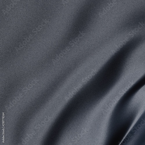 Close-up on a synthetic gray sheet with slightly blue reflection