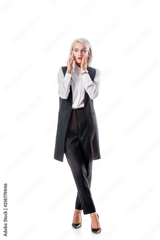 shocked businesswoman in formal wear talking on smartphone isolated on white shocked businesswoman in formal wear talking on smartphone isolated on white