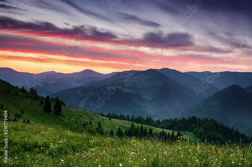 Carpathian mountains summer sunset landscape with dramatic sky and blue mountains