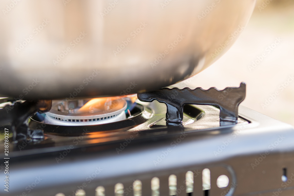 Ταπετσαρία Cooking on camping gas stove.