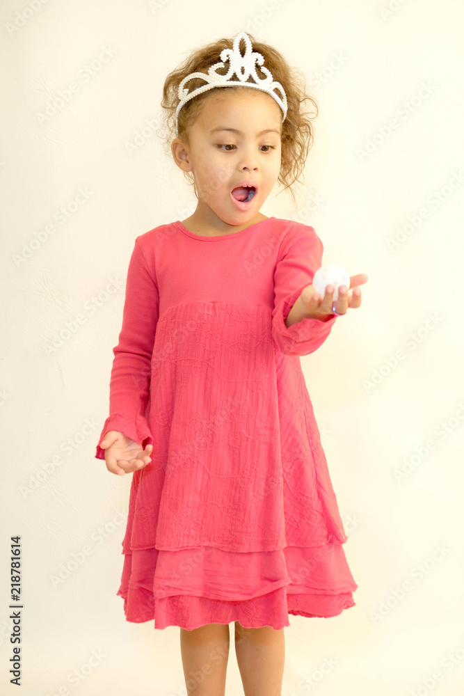 Little girl in pink dress and tiara holding magic energy ball Little girl in pink dress and tiara holding magic energy ball