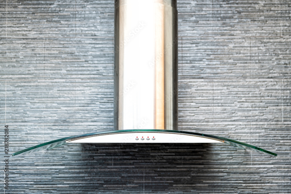 Closeup of modern kitchen exhaust fan above electric, gas, stove,  contemporary stone, tiles, tiled wall finish, backsplash Stock Photo |  Adobe Stock