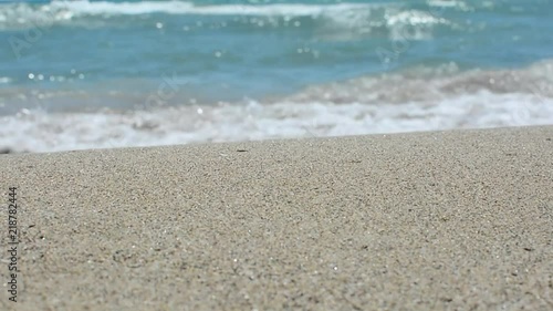 Sea waves over sand beach, holiday background