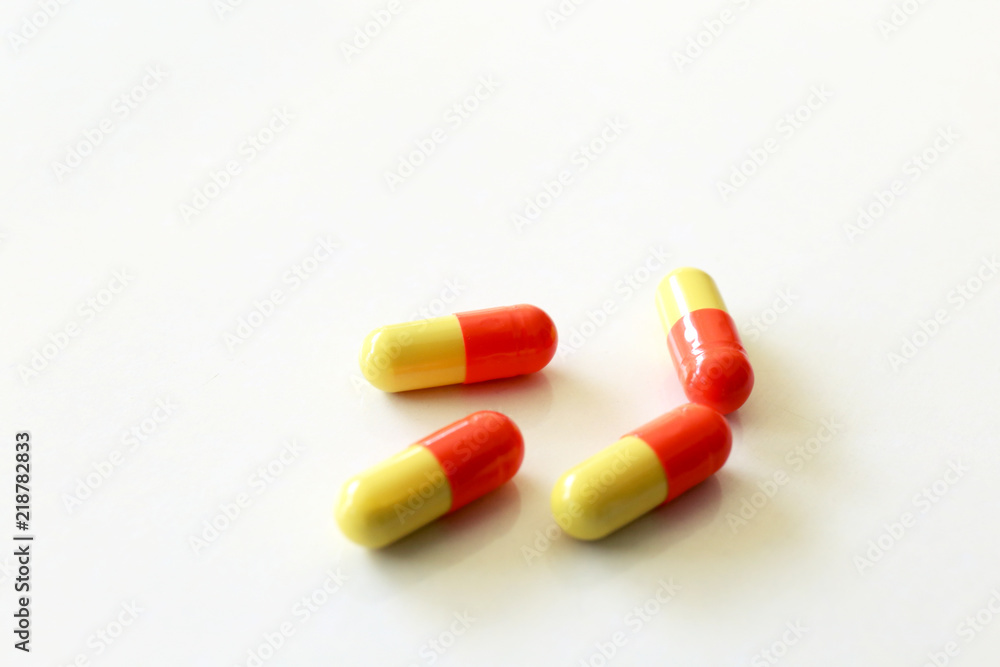 Yellow-red capsules. Some capsules and pills isolated on white background Yellow-red capsules. Some capsules and pills isolated on white background