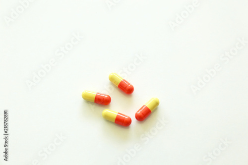 Yellow-red capsules. Some capsules and pills isolated on white background