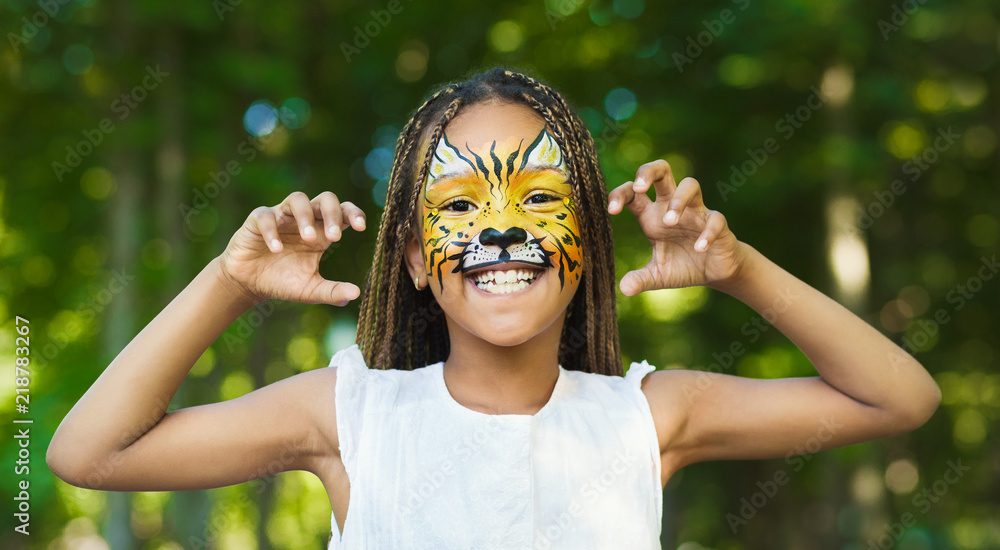 Fototapeta premium Little black girl with tiger face painting
