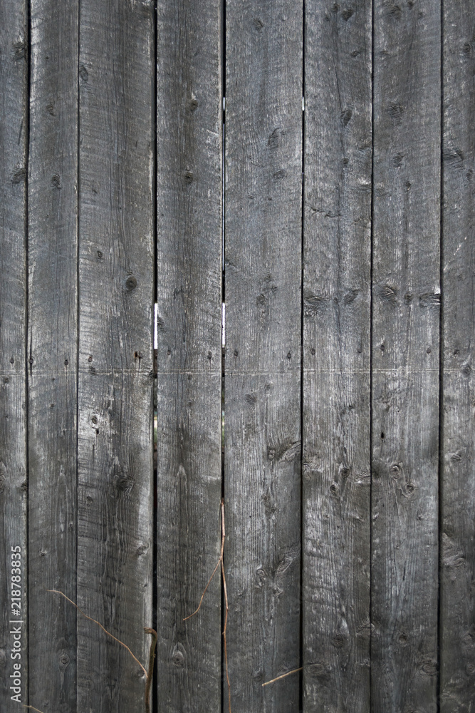 Fototapeta premium Grungy background of peeling flaking black paint on wooden boards
