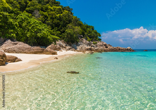 Crystal clear shallow water, shimmering amidst the azure blue ocean and the powdery white sand surrounded by rocks & lush trees makes Rawa Island a tropical paradise within the Perhentian archipelago. photo