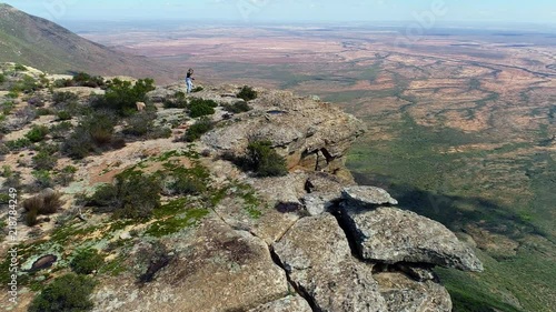 Photographer taking a picture from the edge of a cliff