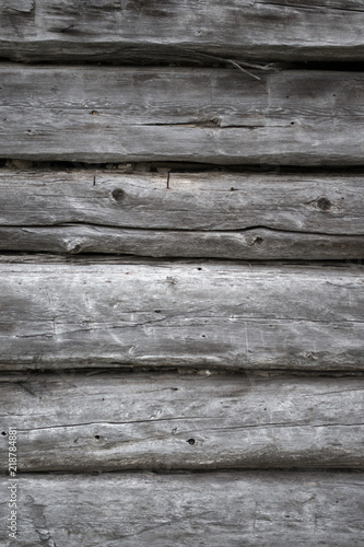 Rough old weathered log cabin background wall closeup