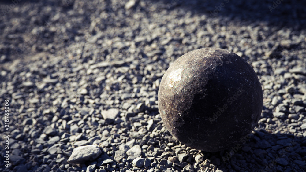 Old petanque balls on the ground. Steel ball on the ground. Light and shadow. Old petanque balls on the ground. Steel ball on the ground. Light and shadow.