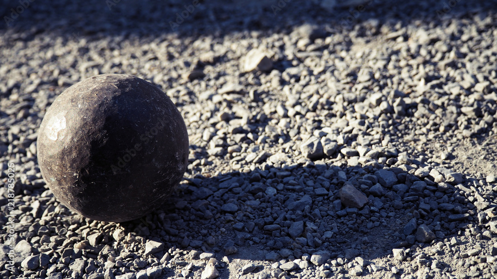 Old petanque balls on the ground. Steel ball on the ground. Light and shadow. Old petanque balls on the ground. Steel ball on the ground. Light and shadow.