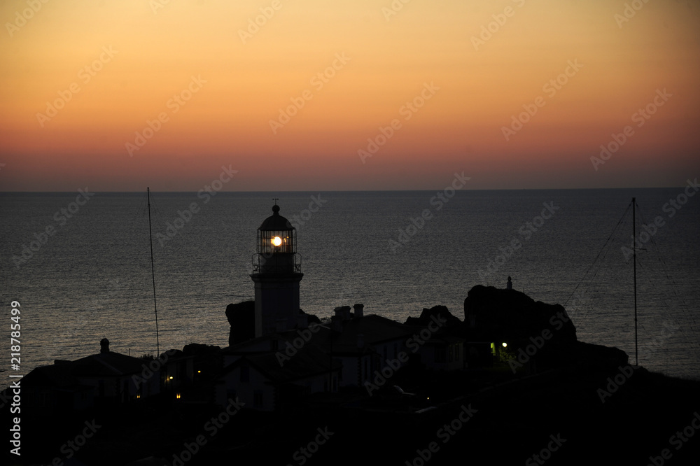  Lighthouse shines at sunset