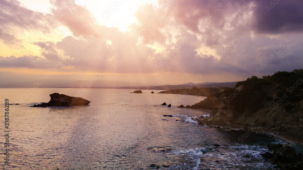 Cyprus beautiful sunrise at the sea with rocks and cloudy sky, natural panoramic background. Summer vacation concept