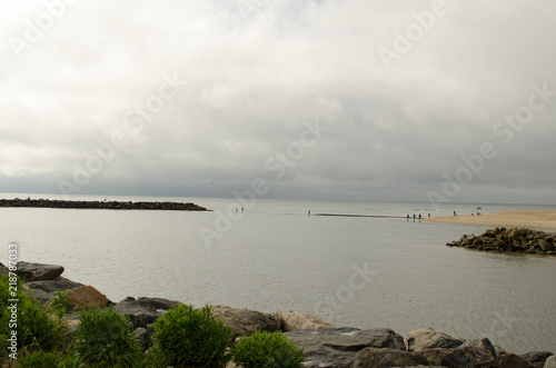 Island with cloudy sky background. Coastline  water