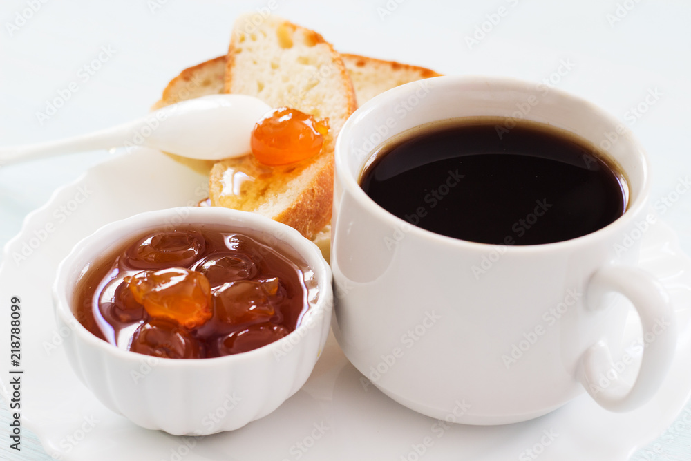 Coffee, jam and homemade bread. Traditional breakfast on a light background. Copy space. Coffee, jam and homemade bread. Traditional breakfast on a light background. Copy space.