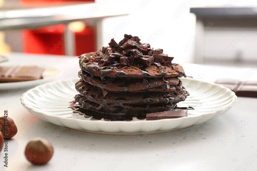 Plate with tasty chocolate pancakes on white table, closeup Plate with tasty chocolate pancakes on white table, closeup