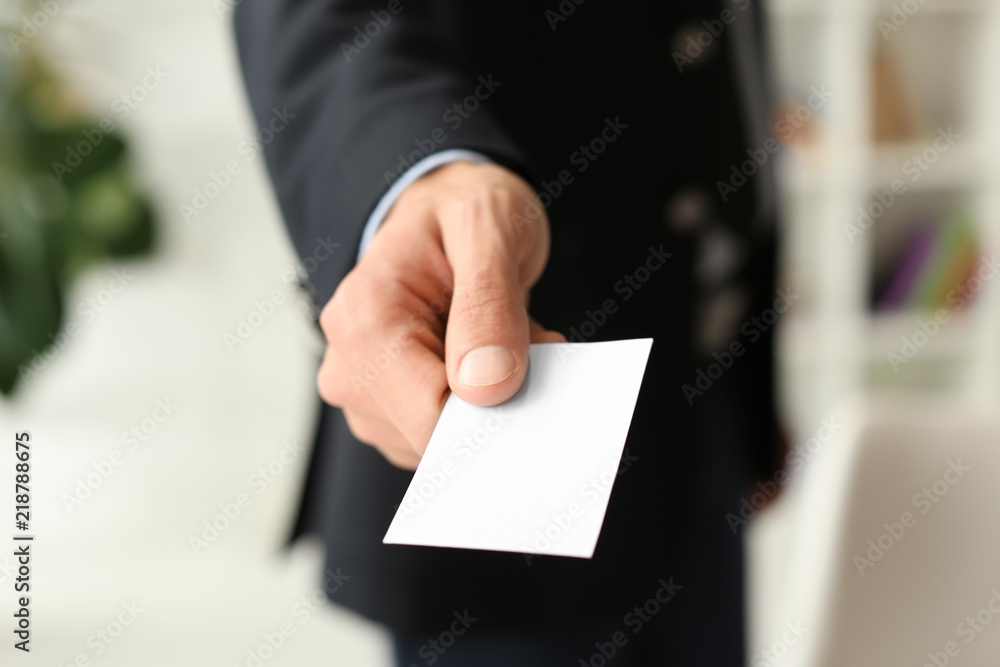 Man with business card in office, closeup Man with business card in office, closeup