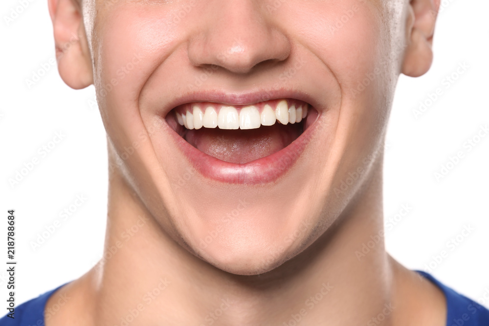 Young man with healthy teeth smiling on white background, closeup Young man with healthy teeth smiling on white background, closeup