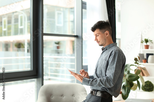 Businessman with tablet com...