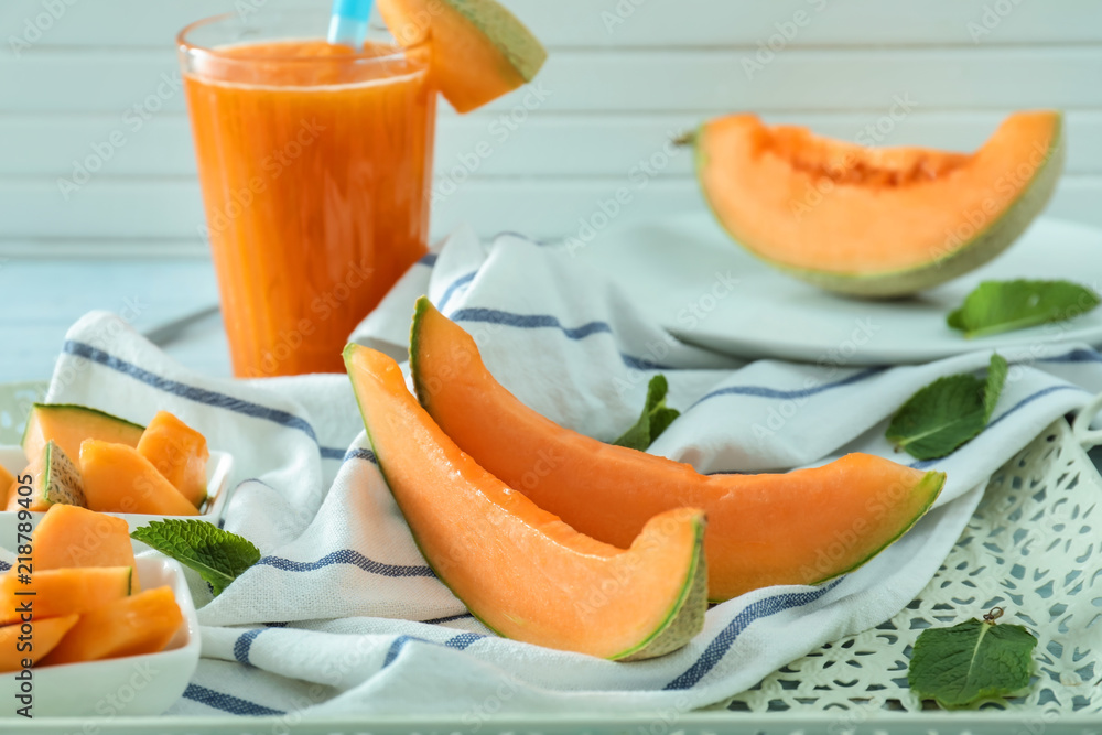 Glass of fresh smoothie and sliced melon on tray Glass of fresh smoothie and sliced melon on tray