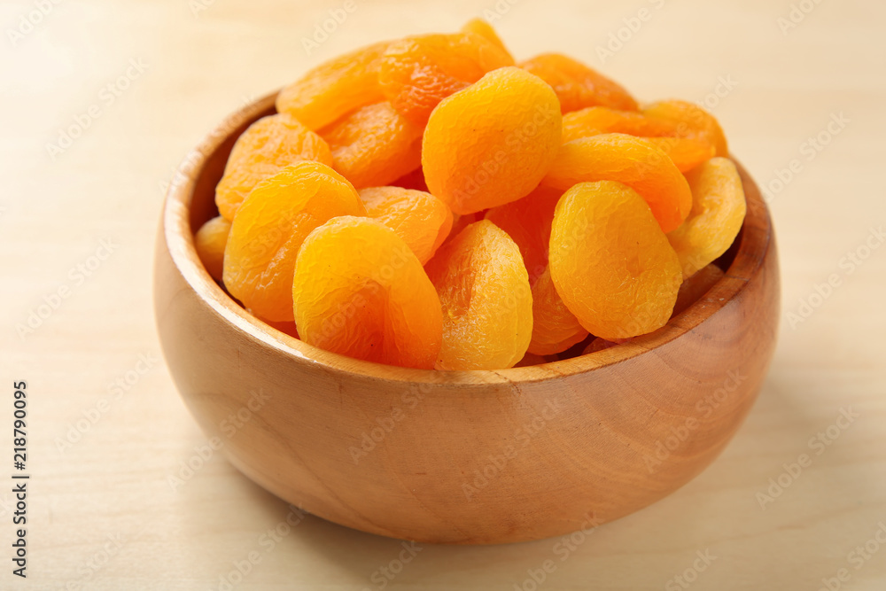 Bowl with dried apricots on wooden table Bowl with dried apricots on wooden table