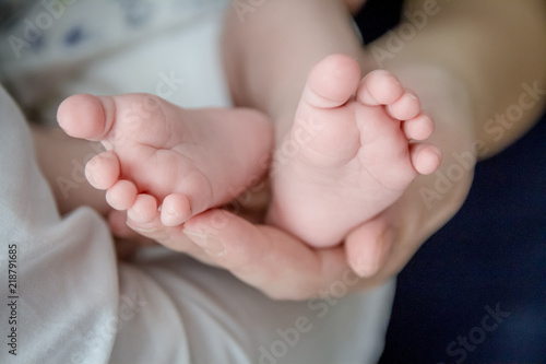 Baby feet cupped into mothers hands