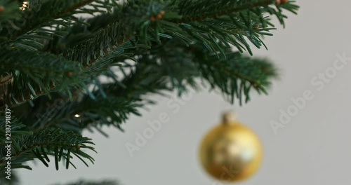 Decorating tree with christmas ornaments photo