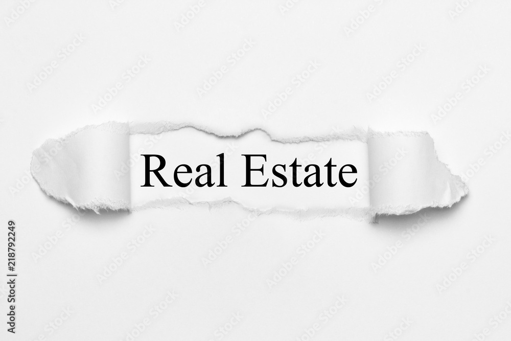 Real Estate on white torn paper Real Estate on white torn paper