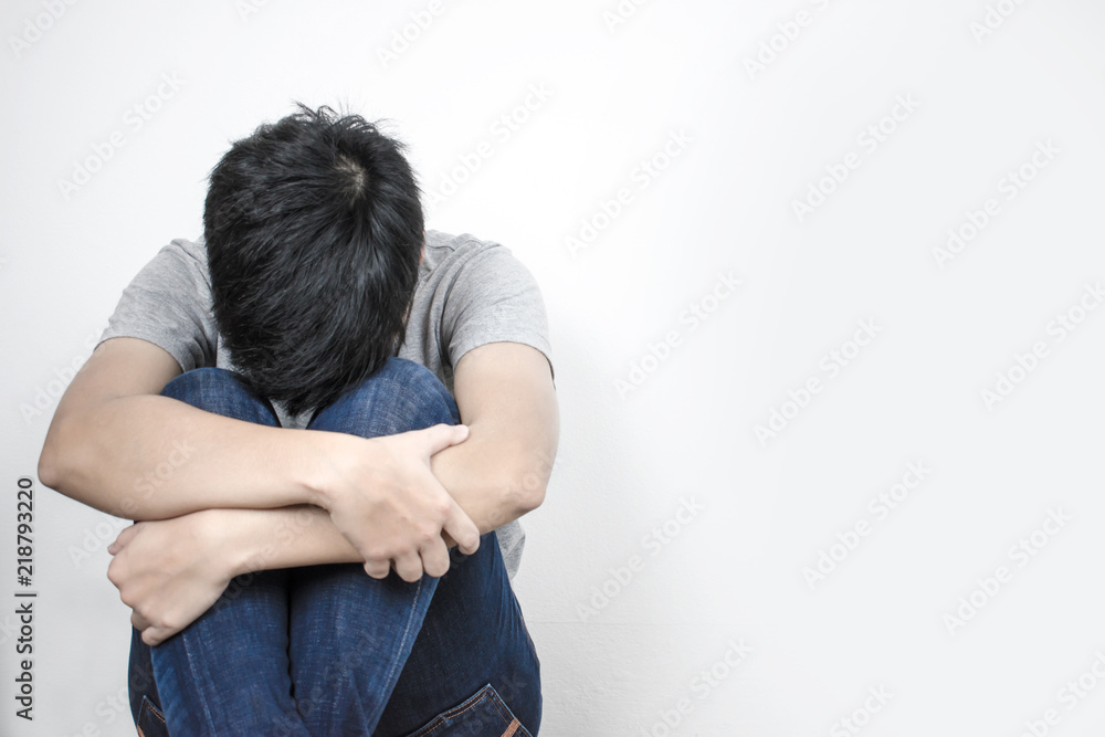 People are hugging their knees and leaning against the wall. Stress life problems. People are hugging their knees and leaning against the wall. Stress life problems.