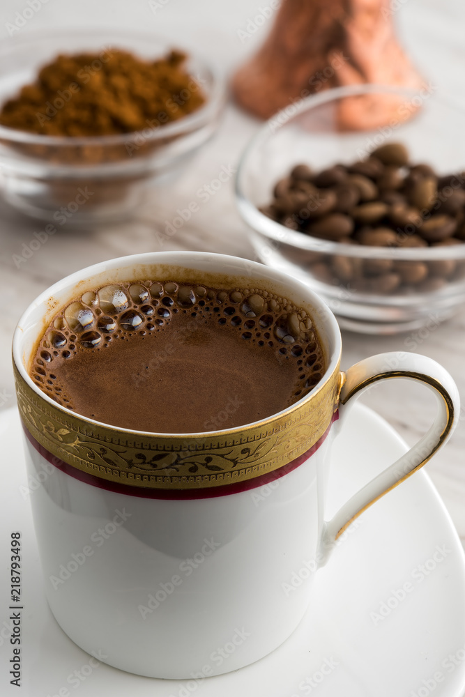 Fototapeta premium Vintage cup of turkish coffee and traditional bronze coffee pot served on marble