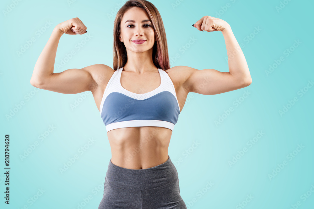 Young woman in sportswear demonstrated her muscular athletic body. Young woman in sportswear demonstrated her muscular athletic body.