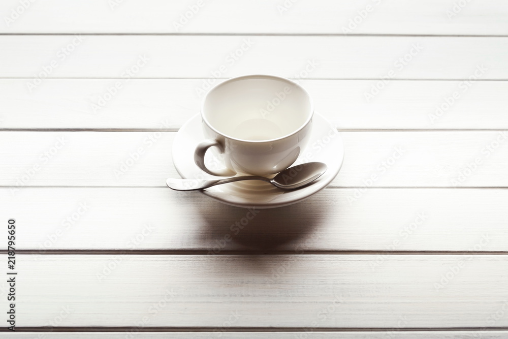Tea cup and saucer on wooden planks Tea cup and saucer on wooden planks