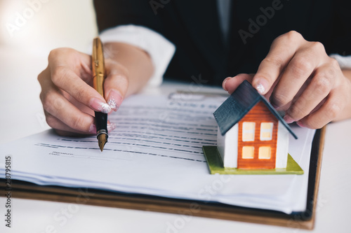 Real estate agent signing contract agreement in office, concept for real estate, moving home or renting property