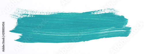 Turquoise brush stroke isolated over white background photo