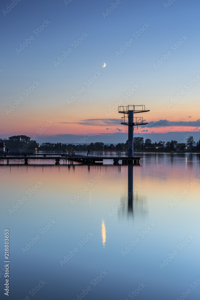 View on  the lake and moon at sunset in Ivano - Frankivsk